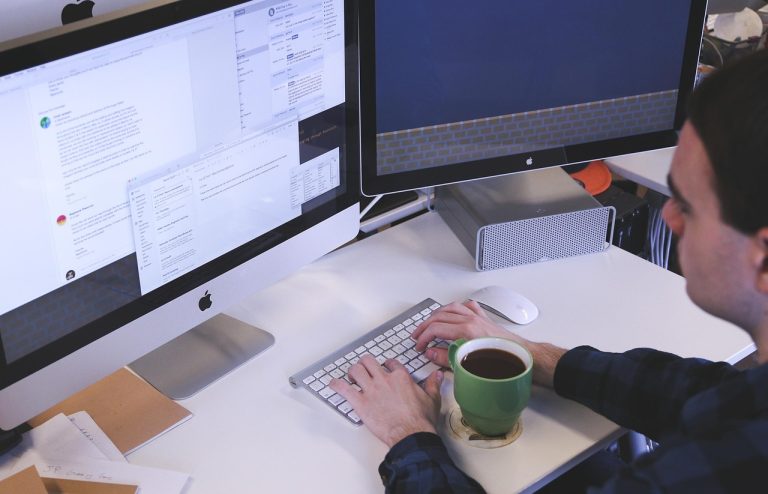 Typing, computer, man — Explore Unique Volunteer Programs Abroad That Offer More Than Just Travel
