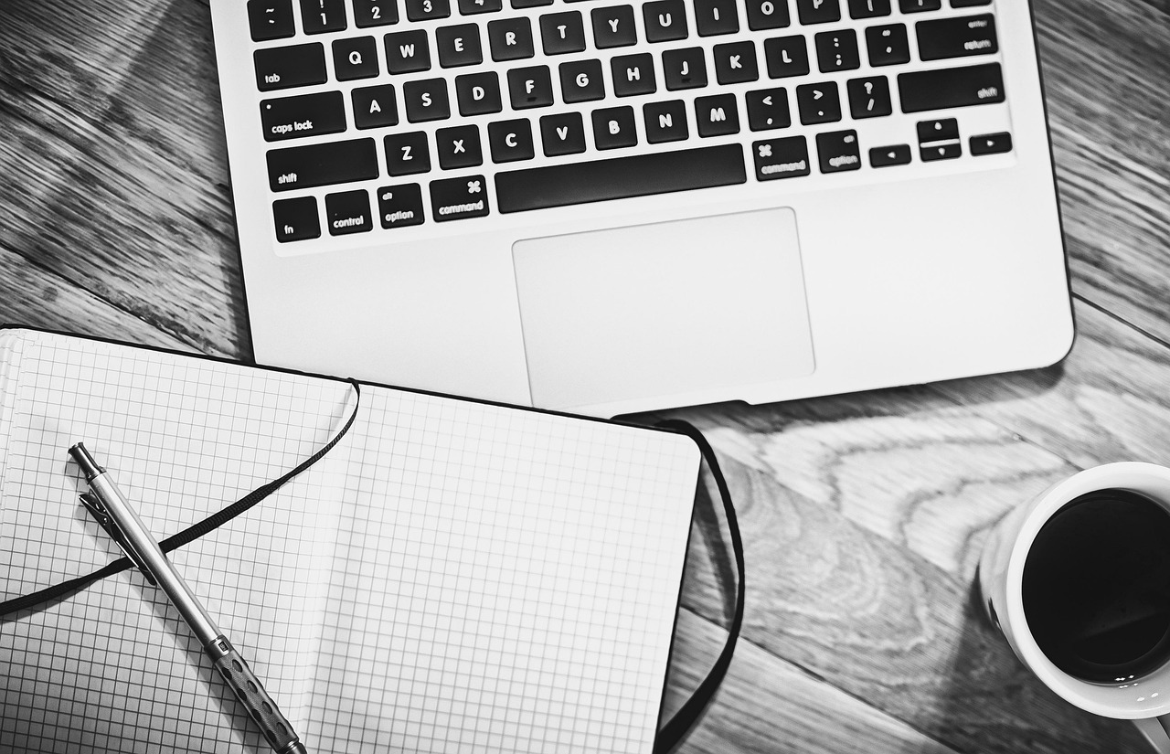 Computer, notebook, coffee — How Reinsurance Enhances Customer Loyalty and F&I Sales in Powersports Dealerships